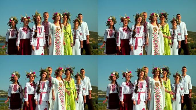 一群穿着民间服装和刺绣服装的美丽斯拉夫男女在大自然中歌唱歌曲。妇女头上的花圈，斯拉夫民族的传统和习俗