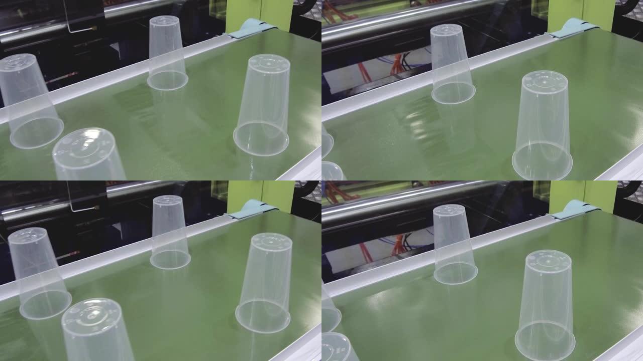 机器人的手在传送带上设置塑料杯