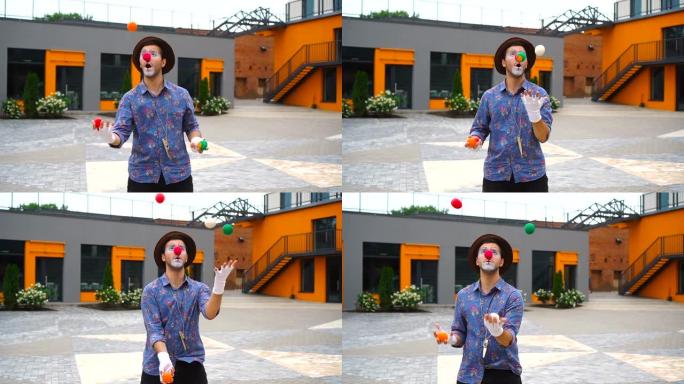 小丑在户外玩杂耍七彩球
