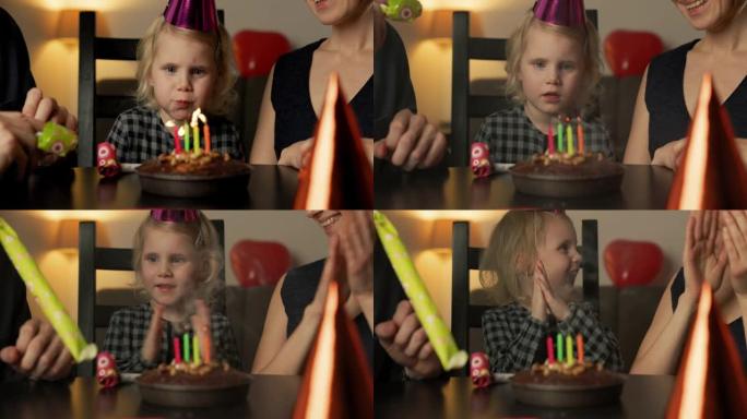 小女孩吹灭生日蛋糕上的蜡烛
