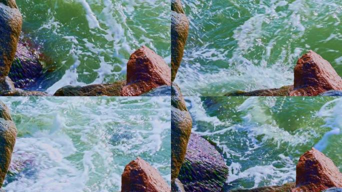 特写海浪撞击海边码头巨石的视频。