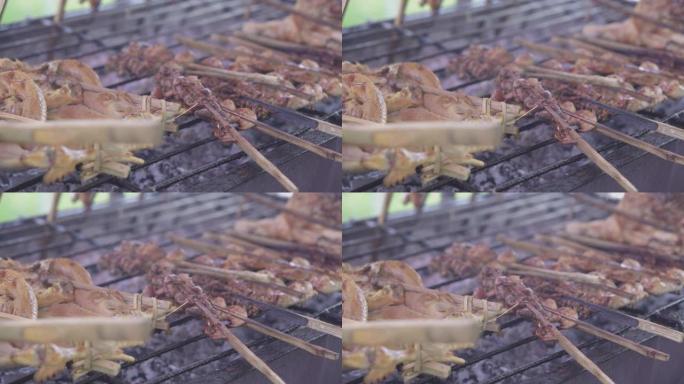 用竹子塞住的草药烧烤鸡肉，炉子上的鸡肉烤架，泰国的街头食品
