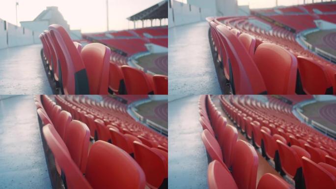 体育场看台上的空红色椅子。