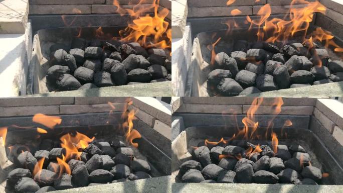 准备烧烤的木炭团块中间燃烧着火