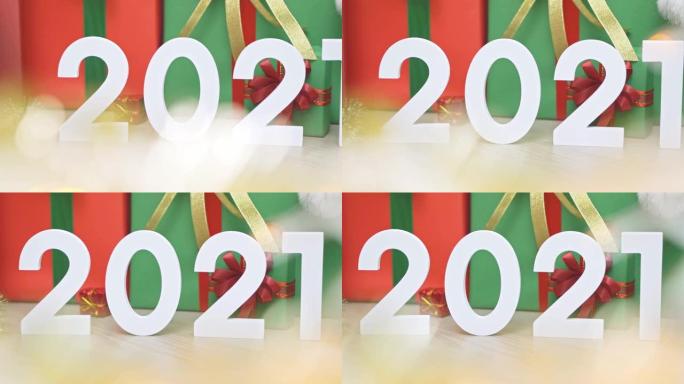 2021新年模型幻灯片拍摄。许多色彩鲜艳的礼物礼盒和装饰，带有金色闪闪发光的bokeh前景。圣诞快乐