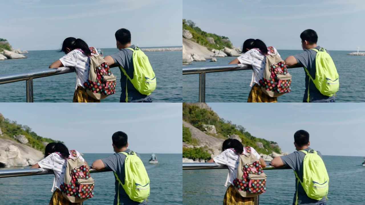 快乐的亚洲儿童戴着口罩在阳光明媚的日子里一起在钓鱼码头享受生活方式的概念。