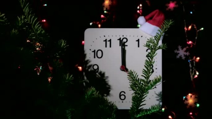 在黑色背景上的新年冷杉树枝上计时。秒针在机械钟的圆圈中移动，并在圣诞节的午夜和前夕显示十二点钟。假日