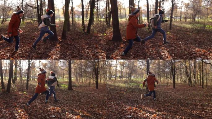 两个男孩在秋天的森林中奔跑