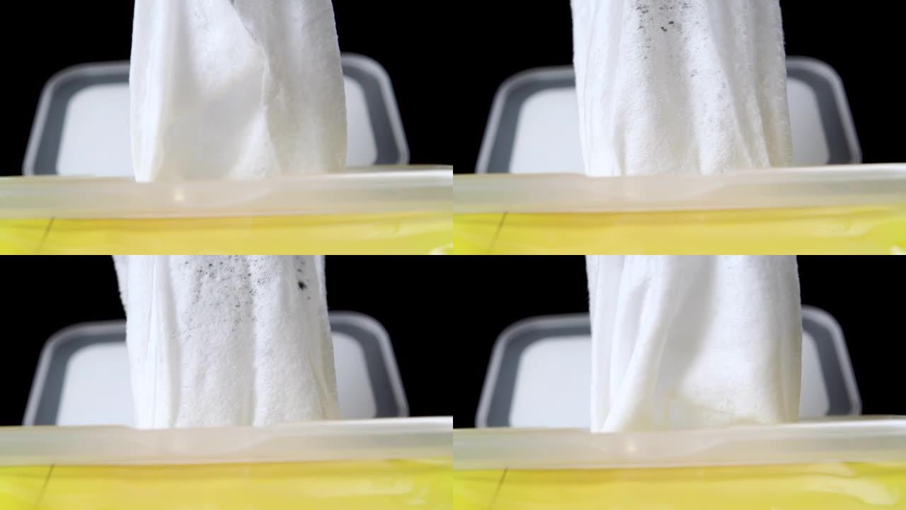 白色一次性湿巾是从黄色塑料盒中抽出的