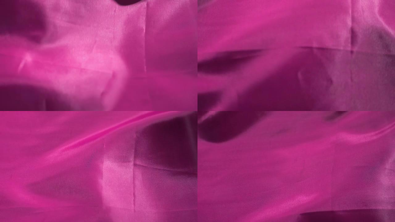 紫罗兰色粉红色纺织品在特写镜头和慢动作中在风中颤抖