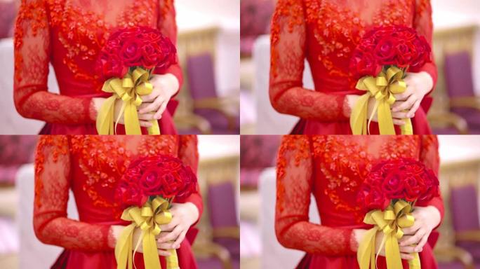 婚礼当天，穿着红色婚纱的新娘手持玫瑰花束