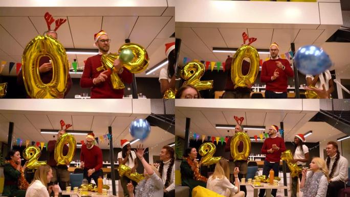 迷人而兴奋的不同同事群体在办公室享受他们2021的新年派对