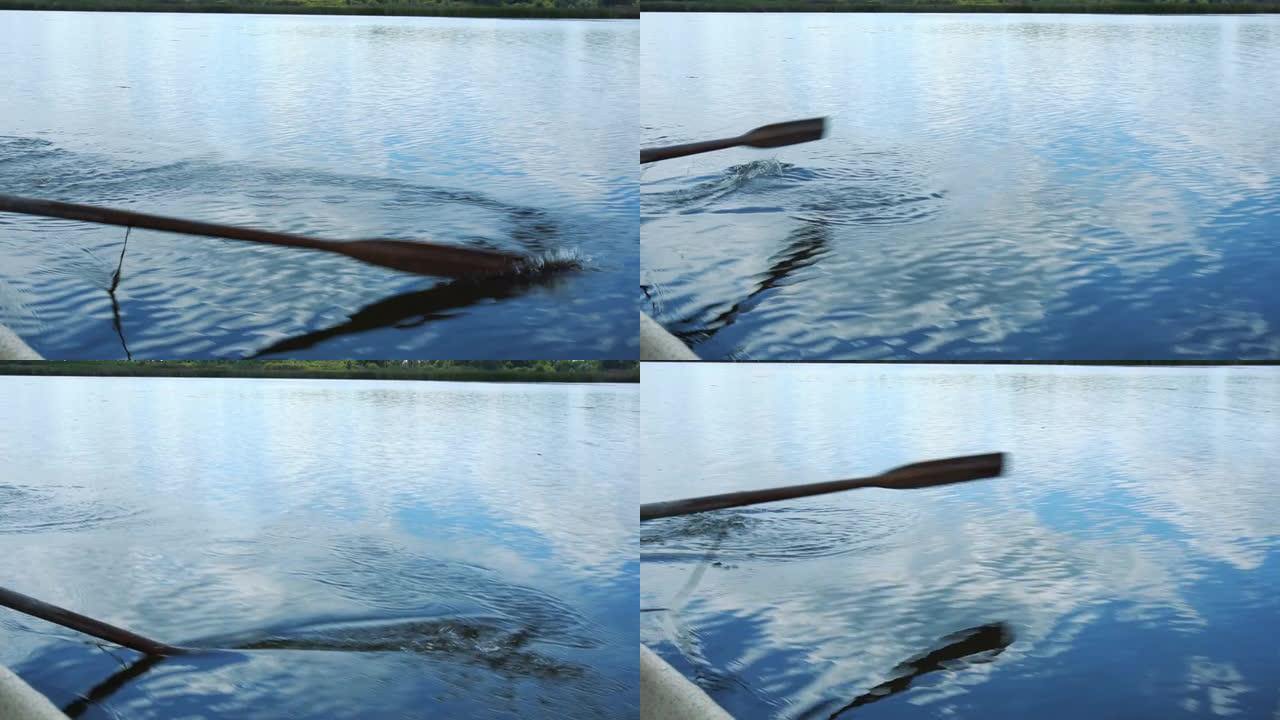 划艇漂浮。桨被水排斥。桨特写