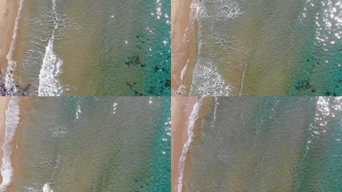 4k空中无人机在野生沙滩上飞溅的海浪，流体运动