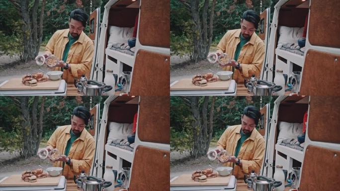 父亲早上在家庭公路旅行中用迷你货车做早餐自制格兰诺拉麦片
