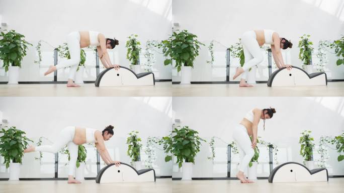 怀孕的美女在健身房锻炼身体做瑜伽动作