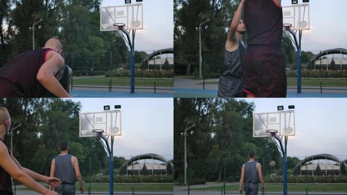 活跃的运动青少年在室外篮球场练习街球。年轻的篮球运动员在户外半场比赛中跳投得分。特写。慢动作