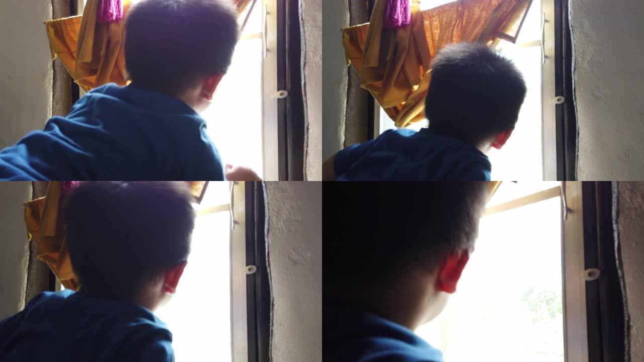 一个小男孩从窗户向外看