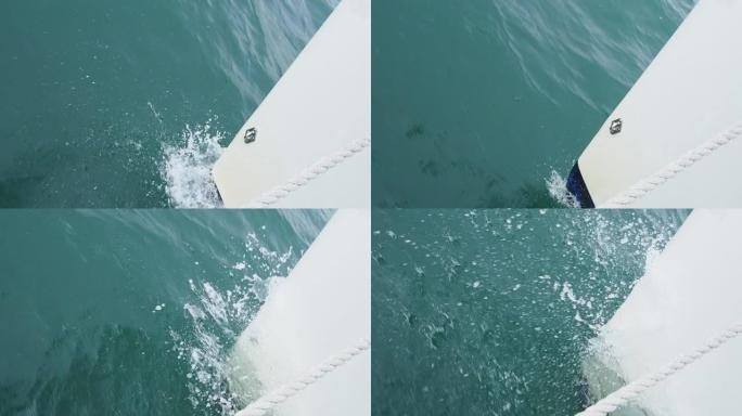 游艇前端在海洋中向前移动的特写镜头。