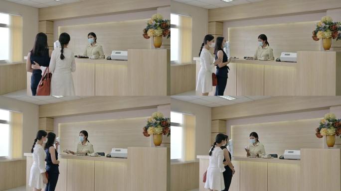 生病的亚洲妇女，姐姐戴着口罩，接待处联系接待员