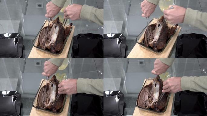 一个男人，一个厨师，用叉子和大刀在玻璃拼盘和木板上切成烤鸭。特写。从顶部看。不露面。4K。