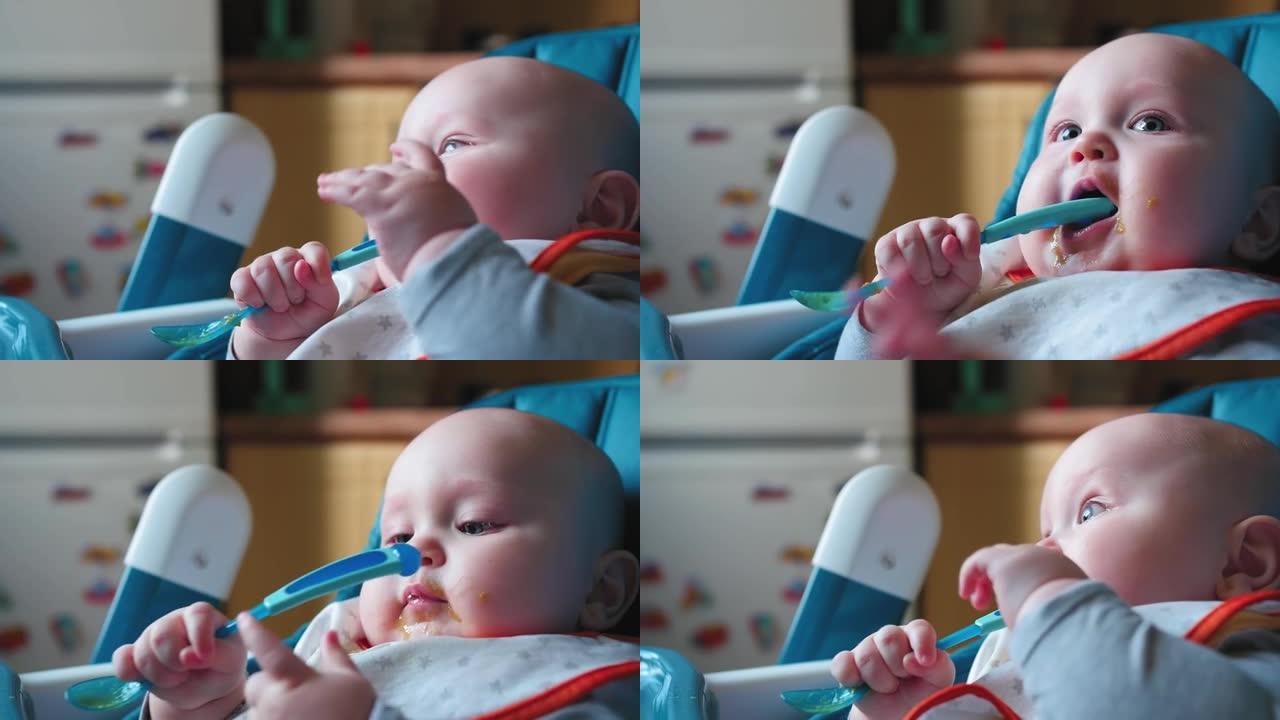 7个月大的婴儿坐在高脚椅上，拿一勺蔬菜。婴儿食品概念。特写镜头。