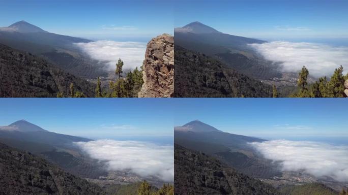 Teide火山和云层的空中全景覆盖了西班牙加那利群岛特内里费岛的Puerto de la Cruz和