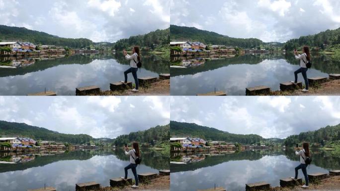 一名女游客拍摄泰国湄宏顺省班乐泰村美丽湖泊的视频