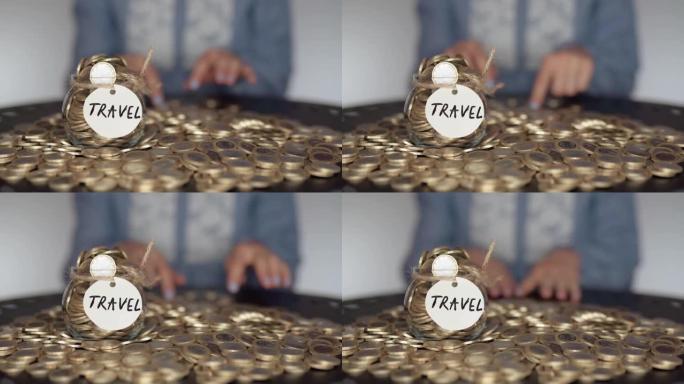 计划预算的概念，女人用手在带有旅行铭文的玻璃罐前景的桌子上计算一叠欧元硬币。货币收入，银行账户