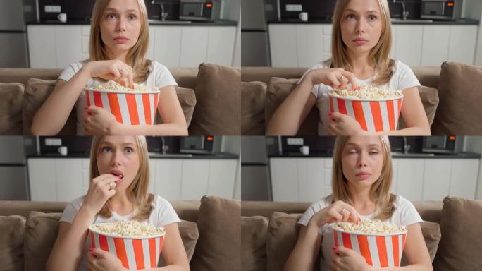 兴奋的女人看电影吃爆米花