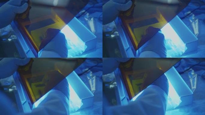 科学家在实验室的紫外线盒下切割凝胶中的DNA，科学家在实验室工作