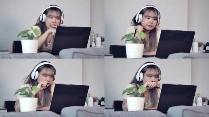 一个亚洲少年女孩在学习休息期间听音乐，看电影和与朋友聊天，并在客厅检疫