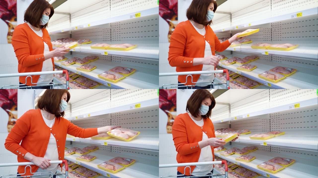 戴医用面具的漂亮女孩在COVID期间在超市买鸡肉