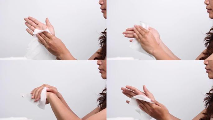妇女用白色软组织纸或湿巾清洁双手，以防止冠状病毒新型冠状病毒肺炎病毒感染。医疗保健和医疗概念。