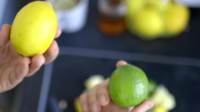 女性的手在水果片上拿着柠檬和酸橙