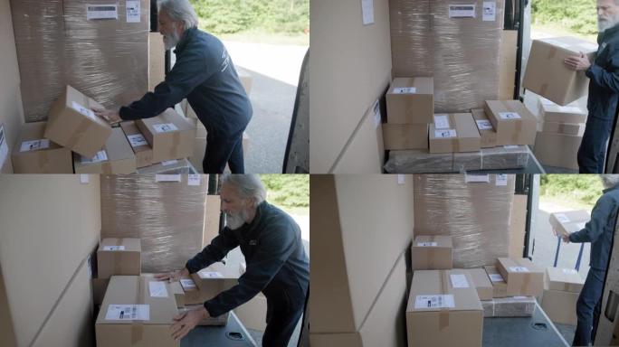 开朗的男快递司机从货车上卸下包裹