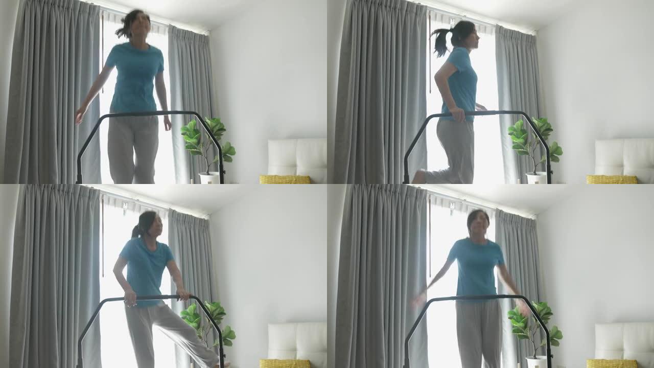 亚洲女人在家里跳迷你蹦床整洁的窗户，生活方式的概念。