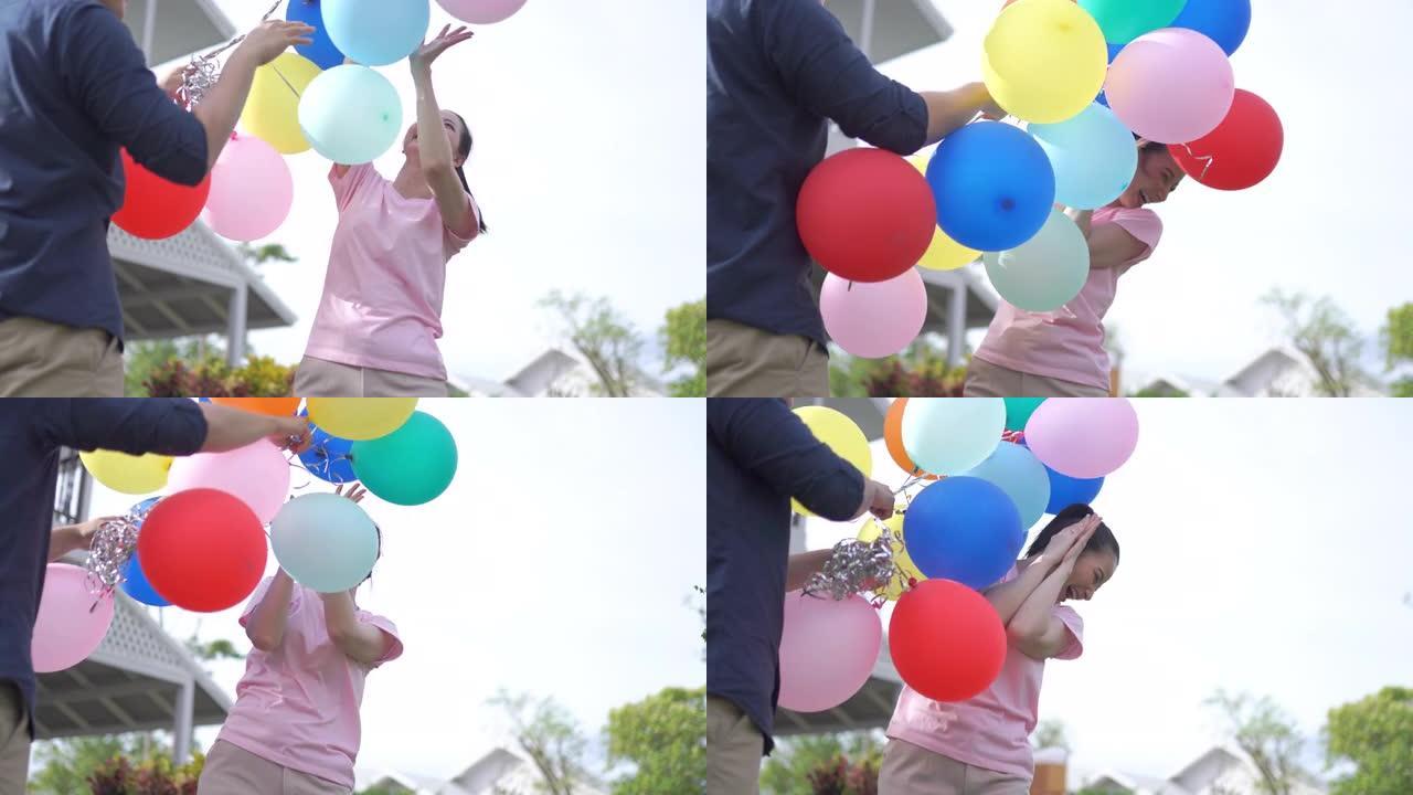 亚洲夫妇手持彩色气球
