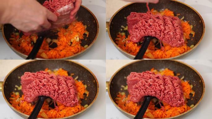 在煎锅里煎肉末、洋葱和胡萝卜。肉酱