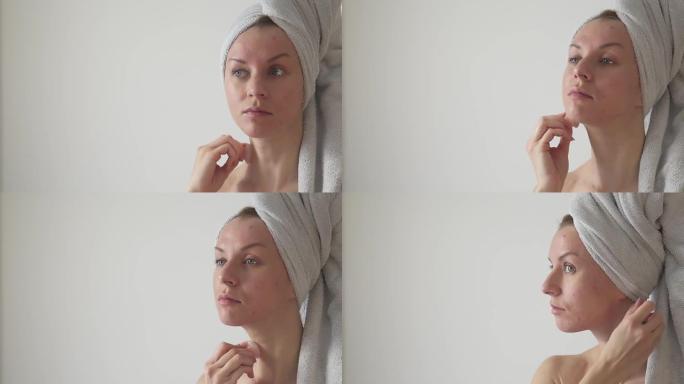 女人用水晶石英按摩脸。
