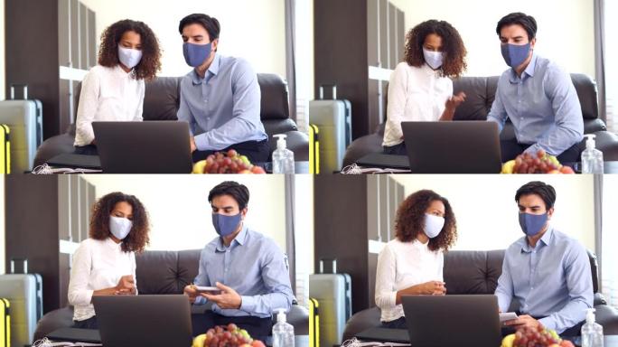 新型冠状病毒肺炎期间，在酒店房间使用笔记本电脑进行视频calloffice视频会议时，带防护面罩的4
