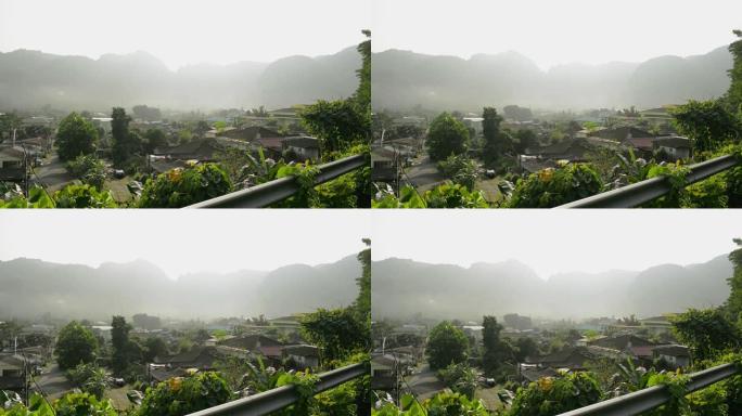 美丽的风景下的山谷小镇。村庄早晨的宁静。在日出的时候，从上面可以看到在自然和雾中居住的房子。