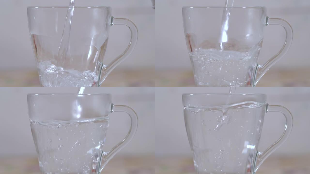 慢动作关闭将热水倒入玻璃杯中，用于在厨房煮茶或咖啡。冲泡茶，将热水从水壶倒入杯子中，蒸汽从杯子中流出