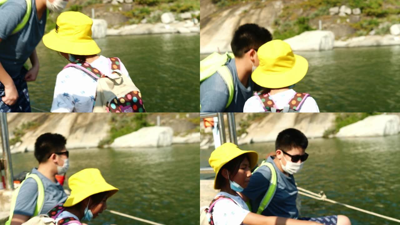 快乐的亚洲儿童戴着口罩在阳光明媚的日子里一起在钓鱼码头享受生活方式的概念。