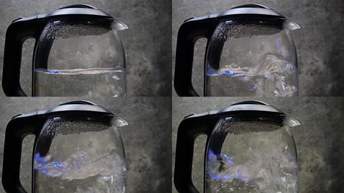 在透明玻璃电热水壶中沸腾有气泡的水。