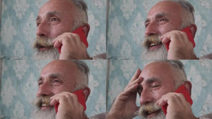 大胡子老人在智能手机上聊天