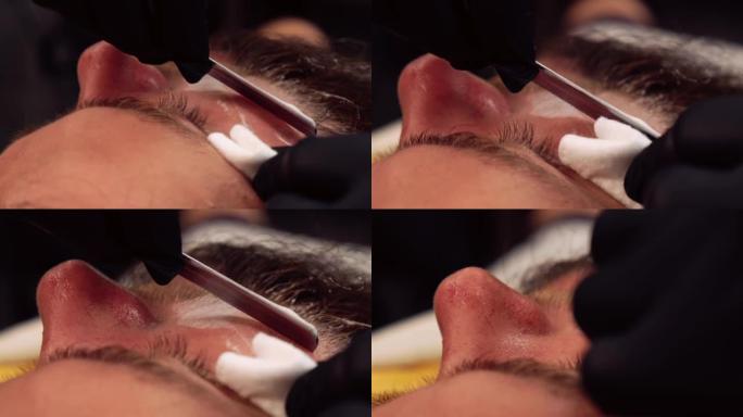 理发师用剃须泡沫刮掉顾客的胡须。留胡子。