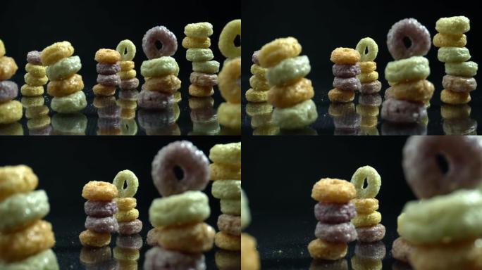五颜六色的谷物箍排成一排在金字塔里。健康五彩麦片的特写镜头。彩色戒指谷物早餐和儿童食品。