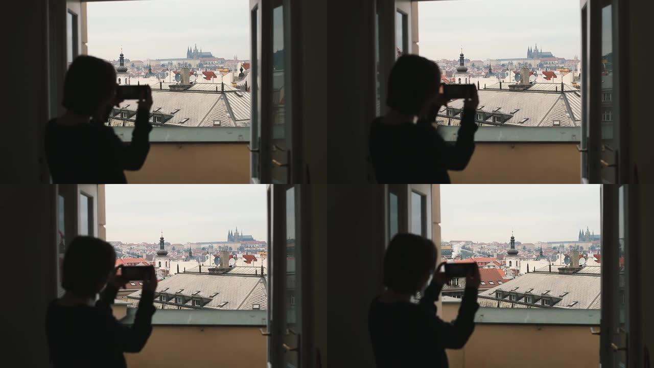 剪影女人使用移动互联网拍摄照片城市智能手机。