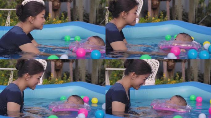 一个男婴和他的母亲在游泳池里玩耍